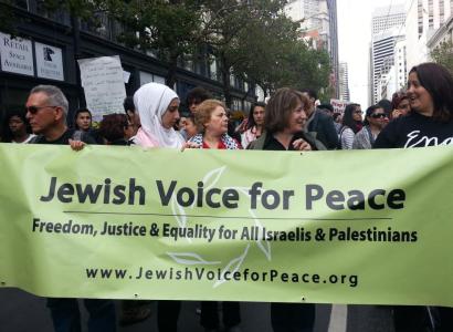 People marching with Jewish Voice for Peace banner