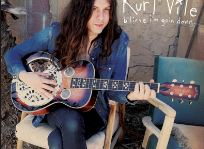 Guy with long hair playing guitar