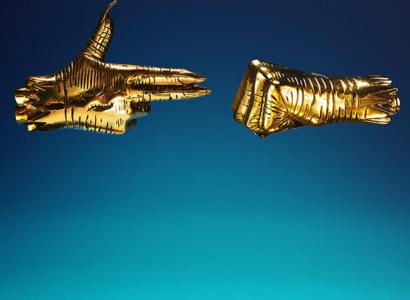 Two gold hands one in a fist one like a gun pointing at each other