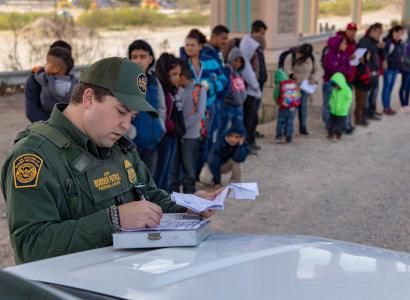 Border patrol and line of immigrants