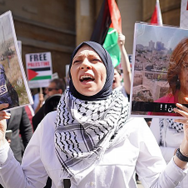 Woman protesting and holding photo of Shireen