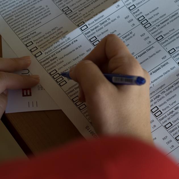 Person voting on paper