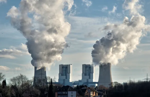 Smoke stacks billowing smoke at plant