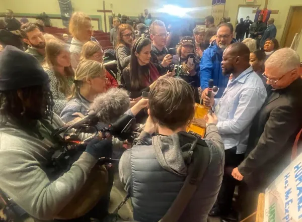 People listening to Haitian man speak