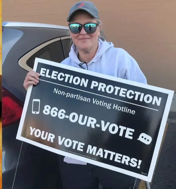 Lady holding Election Protection sign