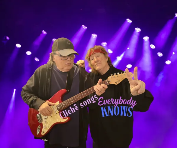 Bob playing guitar and Dan giving peace sign