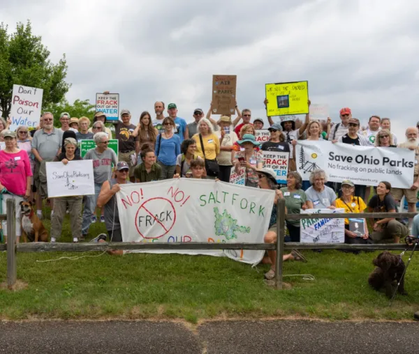 People posing with signs
