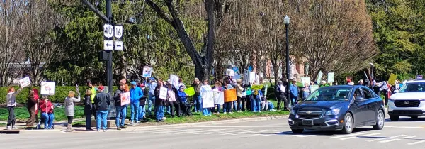 Line of people with signs on street
