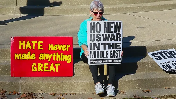 Woman on steps with protest signs