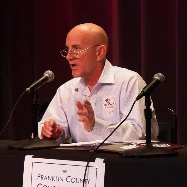 Joe Motil speaking at a podium