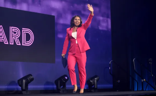 Tulsi Gabbard waving on a stage