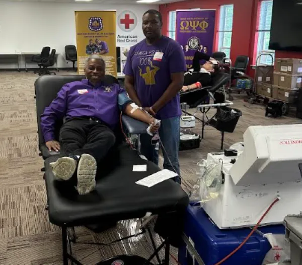 Man lying on bed giving blood