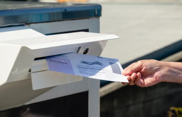 Putting a ballot in a mailbox