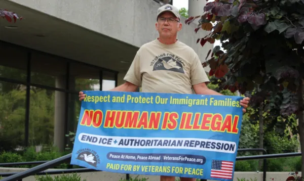 Man holding sign in support of Haitians in Springfield OH