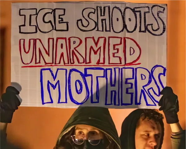 Sign saying ICE shoots unarmed moms
