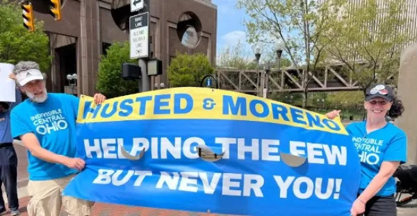 Protestors holding a sign