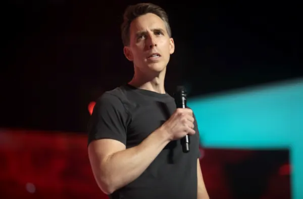 White man talking into a microphone