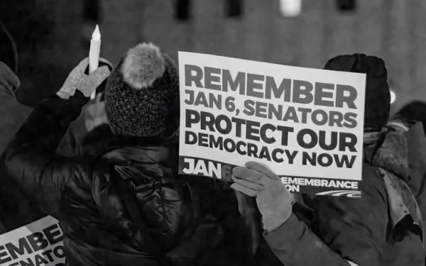 Protester hoding sign Protect our democracy now