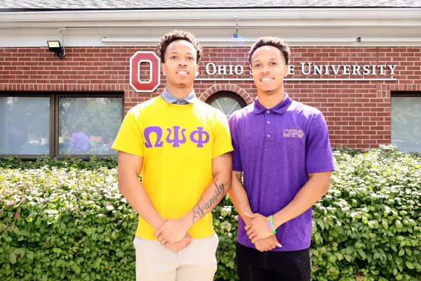 TWo young men posing