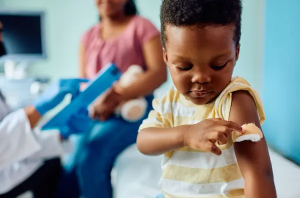 Little boy with a bandaid on his arm