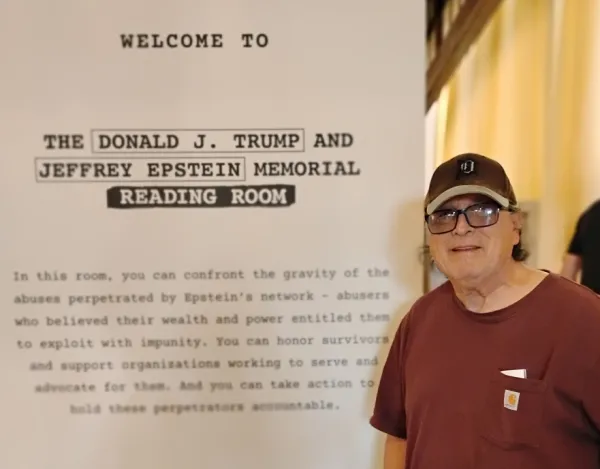 Bob posing by opening signage