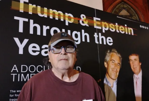 Bob by big poster of Trump and Epstein