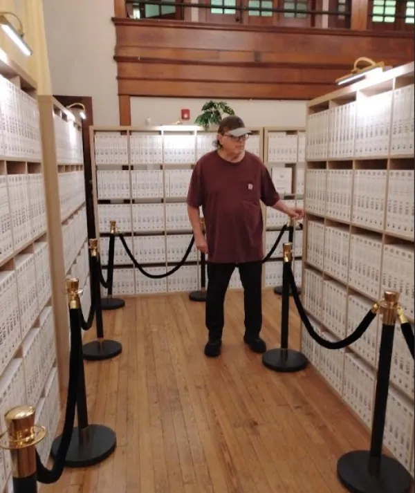 Bob by the bookshelves