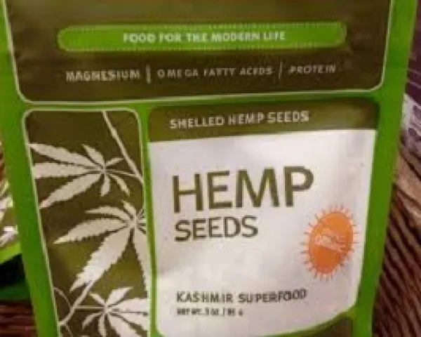 Green bag with white background and words Hemp Seeds and pictures of five leaf plants