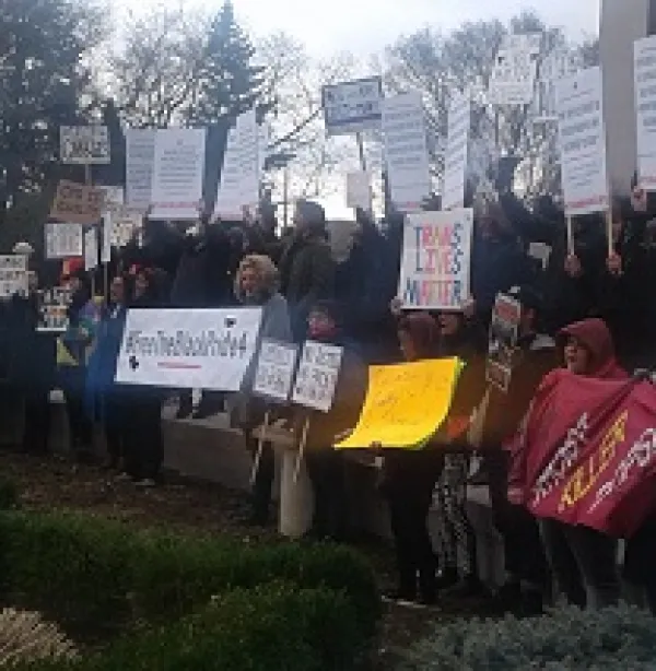 Many people holding signs outside