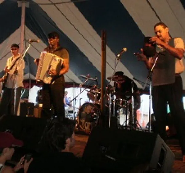 White men playing in a band on a stage