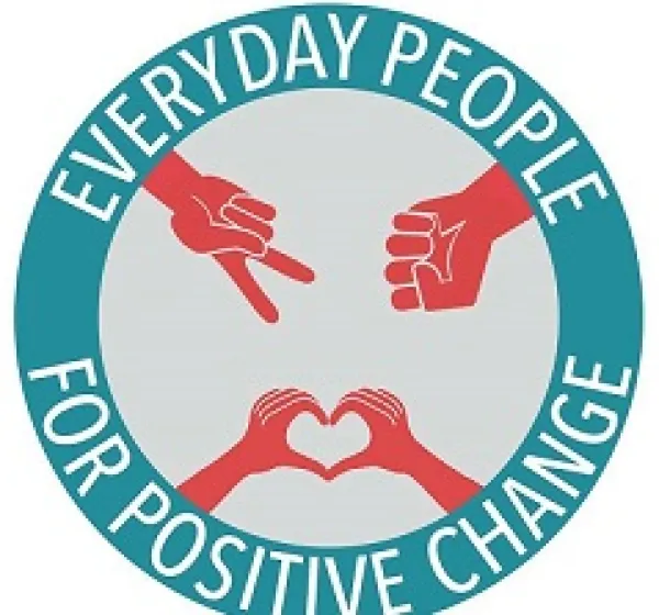 Blue circle with words Everyday People for Positive Change and the word Columbus at the bottom, red hands in the circle with peace sign, fist and making a heart