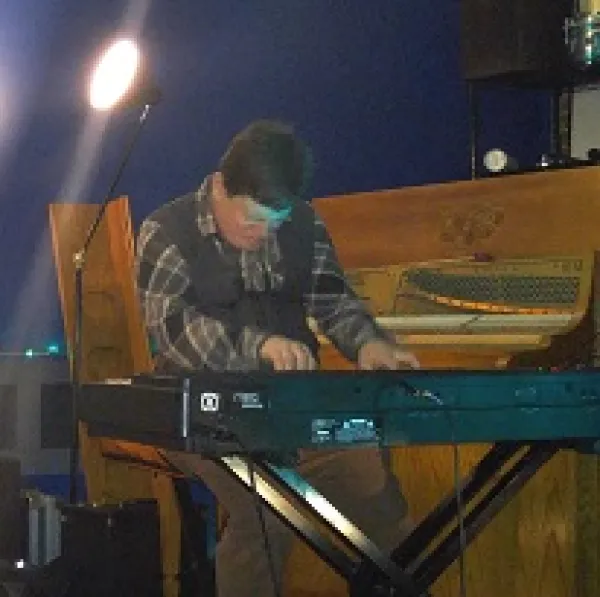 White man playing keyboards 