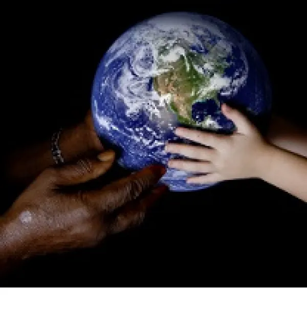 Black hands at left and white hands at right both holding an Earth globe in the middle