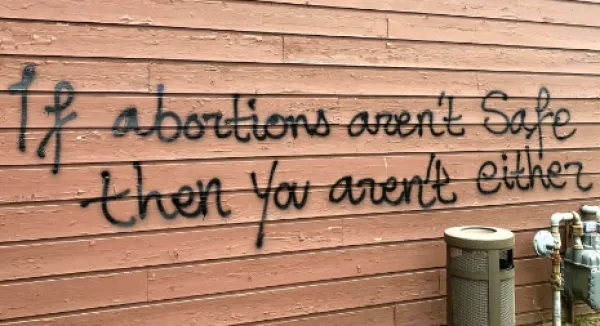 Spray painting on wall saying If abortions aren't safe you aren't either