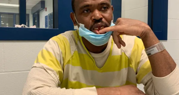 Man showing a spot in mouth where there is a gap.