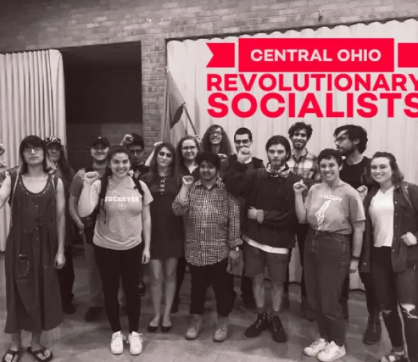 People posing in front of poster