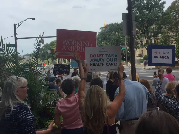 People holding signs about health care