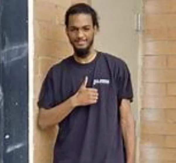 Young man giving a thumbs up sign