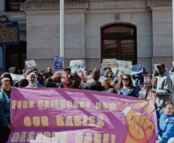 Protest with sign Fund Childcare Now