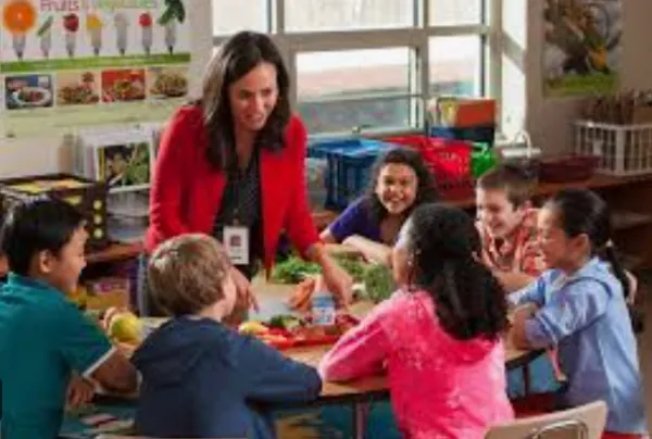 Young student with teacher in classroom