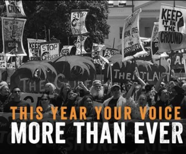 Black and white photo of crowd of people at rally and words Your Voice More than Ever