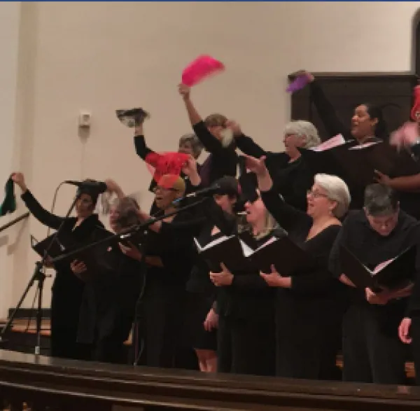 Women singing and waving scarves
