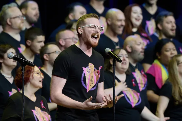 Man singing in front of chorus