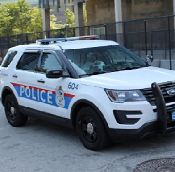 White SUV police vehicle with red and blue on the side saying POLICE