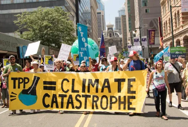 People marching with large banner about climate catastrophe