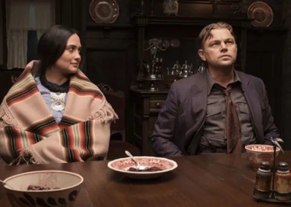 Native woman and white man at a dinner table
