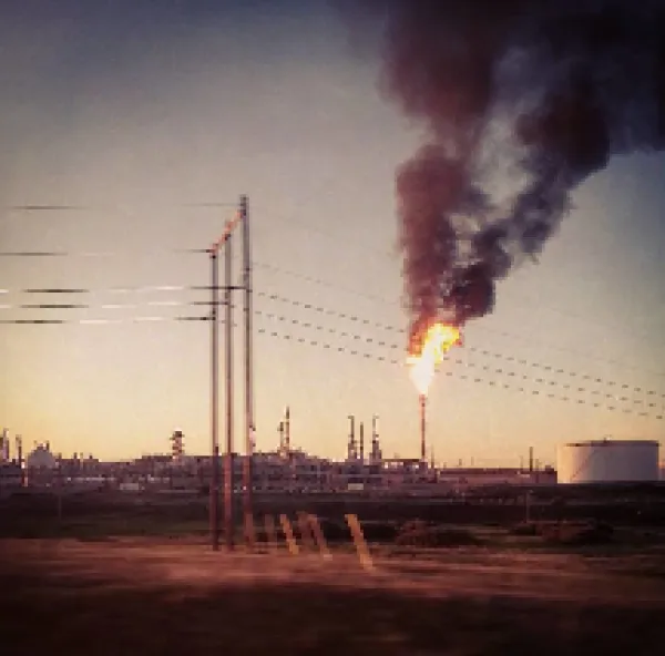 Smoking smokestacks and electrical poles with wires