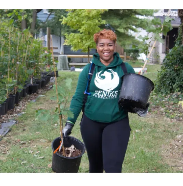 Woman with trees in pots