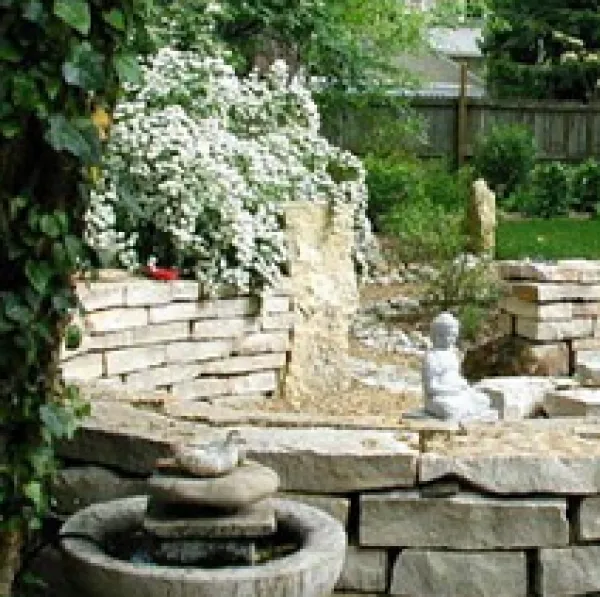 White stone fountain and pretty landscaping