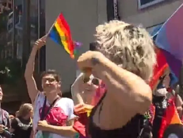 People dancing and a rainbow flag flying